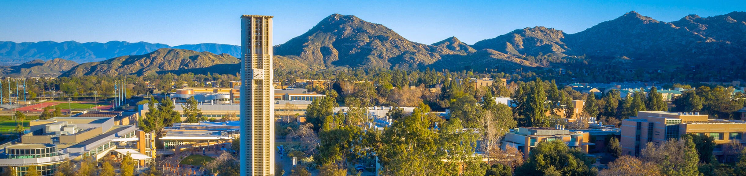 Aerial view of UCR Campus, Bell Tower and mountains (c) UCR/Stan Lim