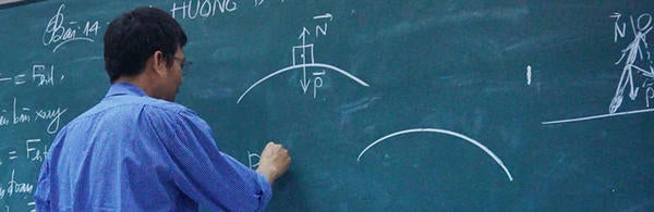 Math Teacher in front of green board