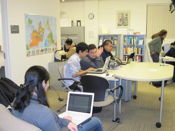students working on laptops at tables