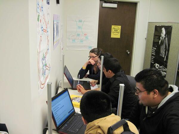 students collaborating on laptops